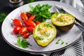 Avocado baked with egg and fresh salad. Vegetarian dish.