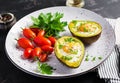 Avocado baked with egg and fresh salad. Vegetarian dish.