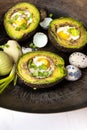 Avocado baked with quail eggs, fresh onion