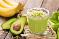 Avocado and banana smoothie with oats with ingredients in glass jar on wooden background Royalty Free Stock Photo