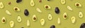 Avocado banner. Background made from isolated Avocado pieces on olive color background. Flat lay of fresh ripe avocados and