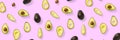 Avocado banner. Background made from isolated Avocado pieces on pink background. Flat lay of fresh ripe avocados and avacado