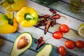 Avocado, bell peppers, tomatoes, chili peppers, broccoli and olive oil Royalty Free Stock Photo