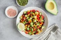 Avocado, black bean, corn and bell pepper salad in white bowl