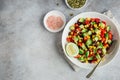 Avocado, black bean, corn and bell pepper salad in white bowl