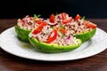 Avocado boats stuffed with tuna, red onion and cherry tomatoes.