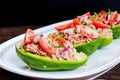 Avocado boats stuffed with tuna, red onion and cherry tomatoes.