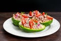 Avocado boats stuffed with tuna, red onion and cherry tomatoes.