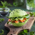 Avocado burger with salted salmon and fresh vegetables.