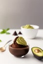 Avocado chocolate mousse dessert in glass on a white background with copy space Royalty Free Stock Photo