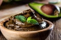Avocado chocolate mousse in olive wooden bowl Royalty Free Stock Photo
