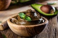 Avocado chocolate mousse in olive wooden bowl Royalty Free Stock Photo
