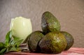 Avocado cream on the wooden surface with fresh fruits and leaves