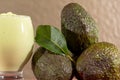 Avocado cream on the wooden surface with fresh fruits and leaves