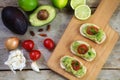 Avocado cream or guacamole on baguette canapes and ingredients l