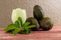 Avocado cream on the wooden surface with fresh fruits and leaves