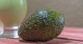 Avocado cream on the wooden surface with fresh fruits and leaves