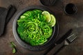 avocado, cucumber, broccoli, asparagus and sweet peas salad, fresh green vegan detox lunch bowl. Royalty Free Stock Photo