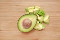 Avocado cut half and chopped on wooden board background Royalty Free Stock Photo