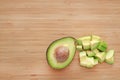 Avocado cut half and chopped on wooden board background with copy space Royalty Free Stock Photo