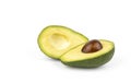 An avocado cut in half, one half of which is pitted. The avocado lies on a white background, which creates a contrast Royalty Free Stock Photo