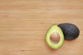 Avocado cut in half on wooden board background Royalty Free Stock Photo