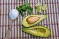 Avocado cut in halves accompanied by salt and lemon Royalty Free Stock Photo