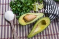 Avocado cut in halves accompanied by salt and lemon. Royalty Free Stock Photo