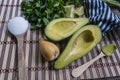 Avocado cut in halves accompanied by salt and lemon Royalty Free Stock Photo