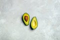 Avocado cut in halves with seed on white grunge background Royalty Free Stock Photo