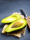 Avocado on dark table. fresh avocado, halfs of avocado