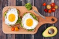 Avocado, egg open sandwiches on paddle board