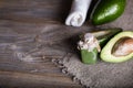 Avocado facial scrub on a wooden surface.