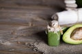 Avocado facial scrub on a wooden surface.