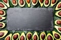 Avocado. Frame made from avocado palta and avocado tree leaves around slate board. Guacamole ingredients. Healthy fat, omega 3. Ha Royalty Free Stock Photo