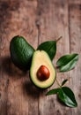 Avocado fruit and leaves on rustic wooden background. Royalty Free Stock Photo