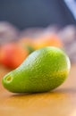 Avocado fuerte with fruits on the background