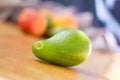 Avocado fuerte with fruits on the background