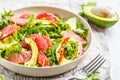Avocado and grapefruit salad in a white plate on a white background. Royalty Free Stock Photo