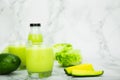 Avocado and green cos salad blended in a glass and bottle, healthy drinking water. horizontal photo Royalty Free Stock Photo