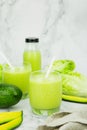 Avocado and green cos salad blended in a glass and bottle, healthy drinking water. vertical photo Royalty Free Stock Photo