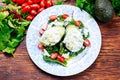 Avocado halves stuffed with cottage cheese and vegetables