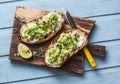 Avocado and labne toast with micro greens on a cutting board, top view. Good fats healthy eating