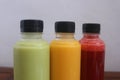 Avocado, mango and strawberry juices served in plastic bottles Royalty Free Stock Photo