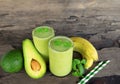 Banana Juice and avocado smoothies and green juice drink healthy, delicious taste in a glass for weight loss on wooden background