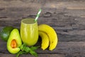 Banana Juice and avocado smoothies and green juice drink healthy, delicious taste in a glass for weight loss on wooden background. Royalty Free Stock Photo