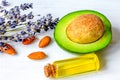 Avocado oil for handmade cosmetics with herb on wooden background