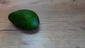 Avocado on old wooden table.