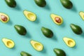 Avocado pattern on blue background. Pop art design, creative summer food concept. Green avocadoes, minimal flat lay