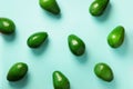 Avocado pattern on blue background. Top view. Banner. Pop art design, creative summer food concept. Green avocadoes, minimal flat